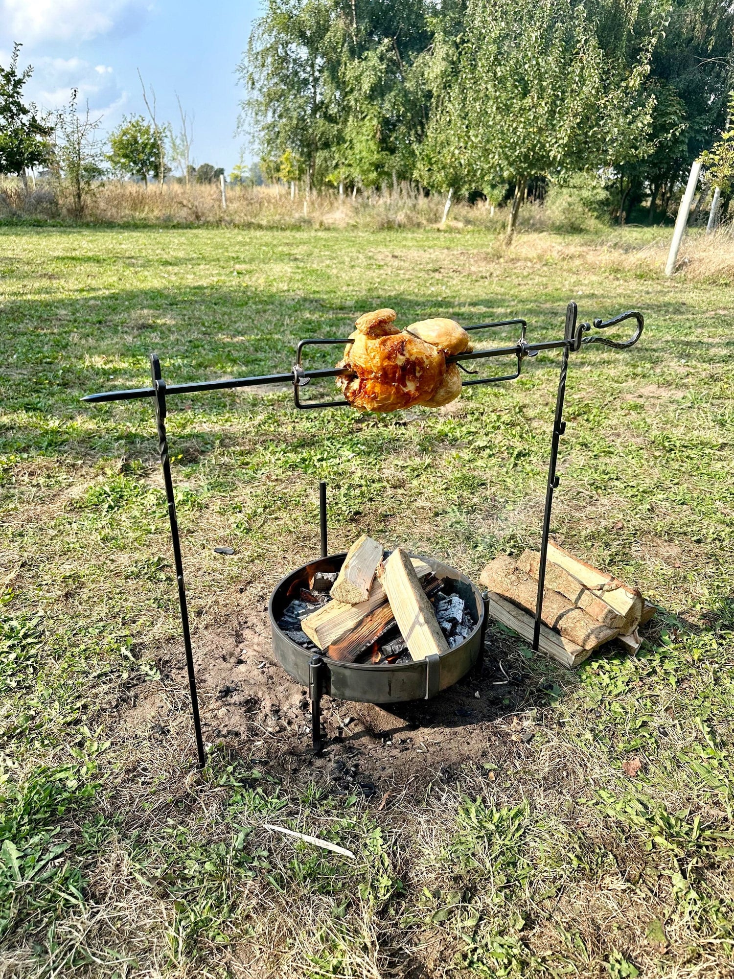 The Large Spit Rotisserie is a portable rotisserie cooking system