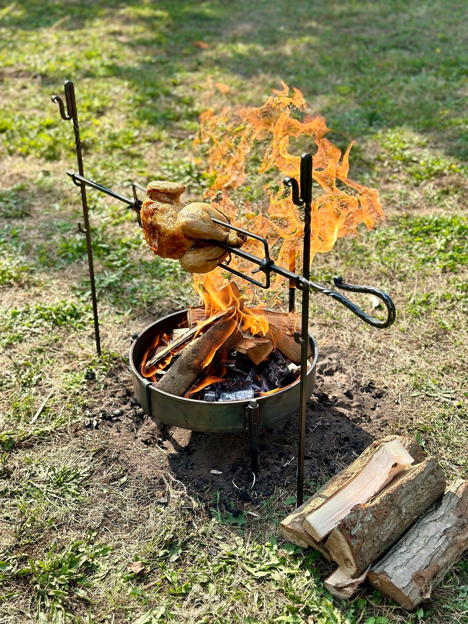 The Large Spit Rotisserie is a portable rotisserie cooking system